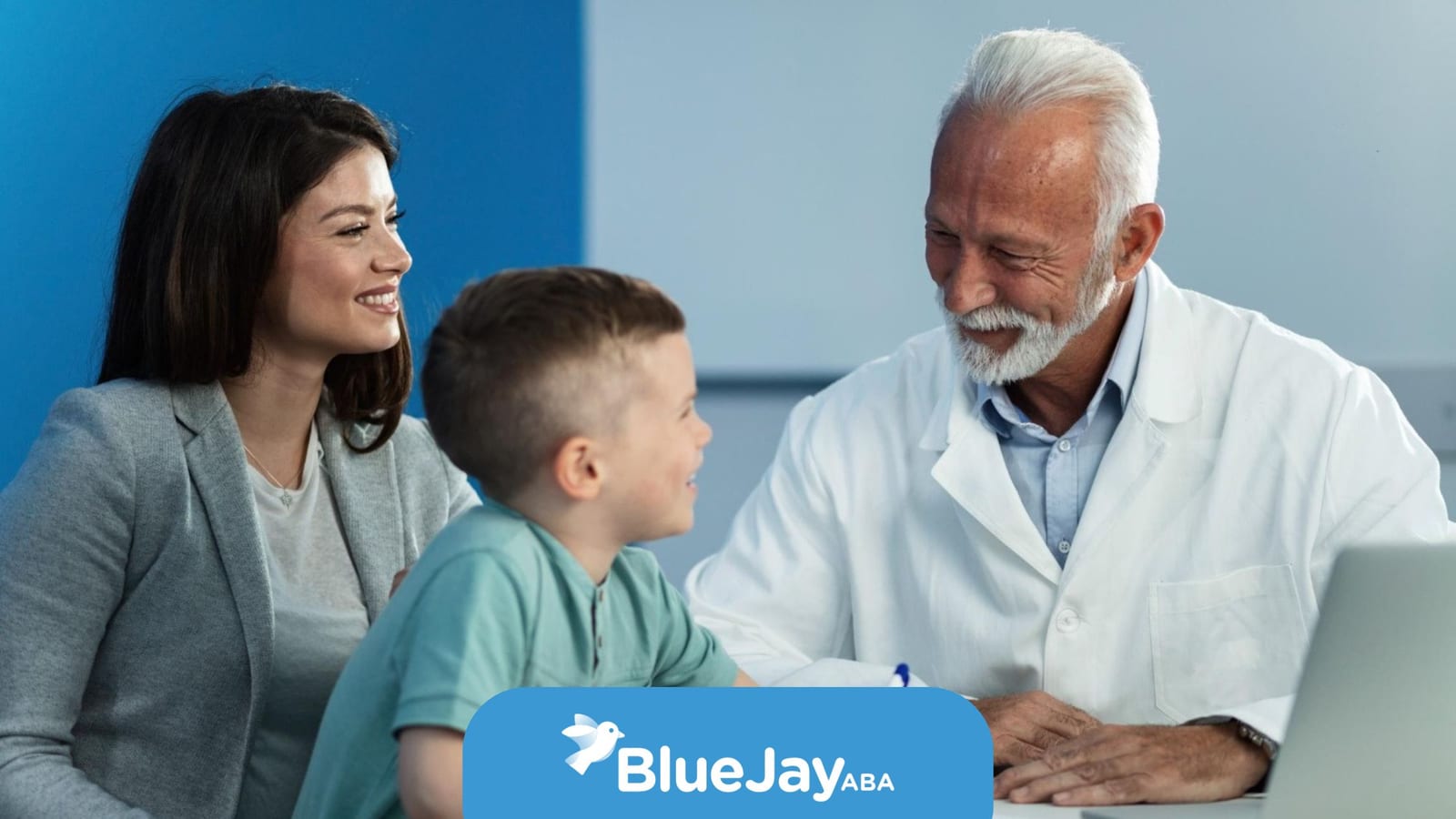 Developmental pediatrician meeting with a young boy and his mother during a consultation.